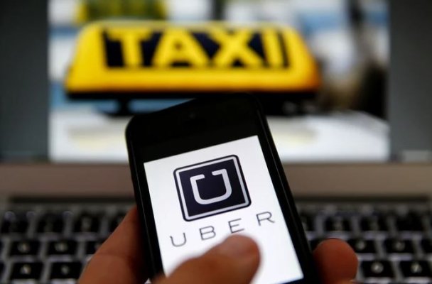 Uber acceptă să plătească o sumă record șoferilor de taxi