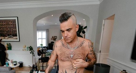 Motivul pentru care Robbie Williams poartă perucă. Starul britanic visează la pletele din tinerețe